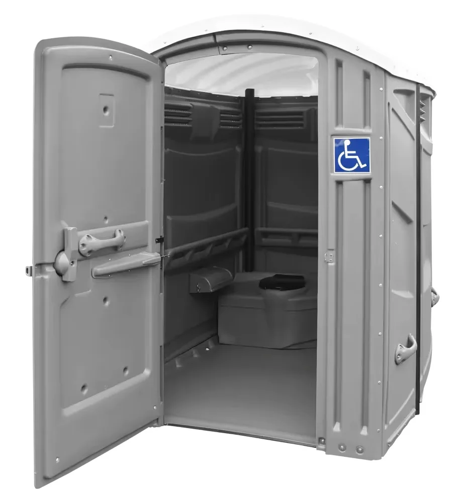 Inside an ADA-compliant portable restroom showing the wide door opening, handrails, and flat floor