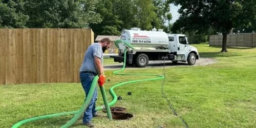 Brower Inc. portable restroom at an Oklahoma construction site with workers in the background