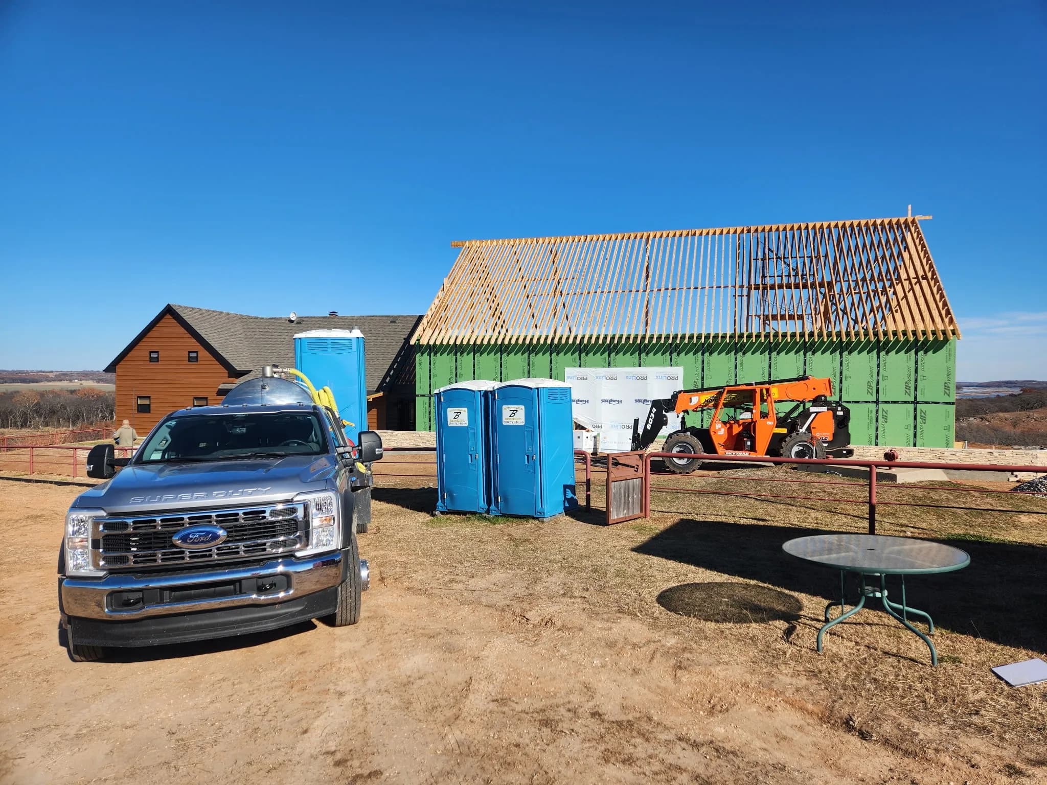 Brower Inc. service truck and portable restrooms at a construction site