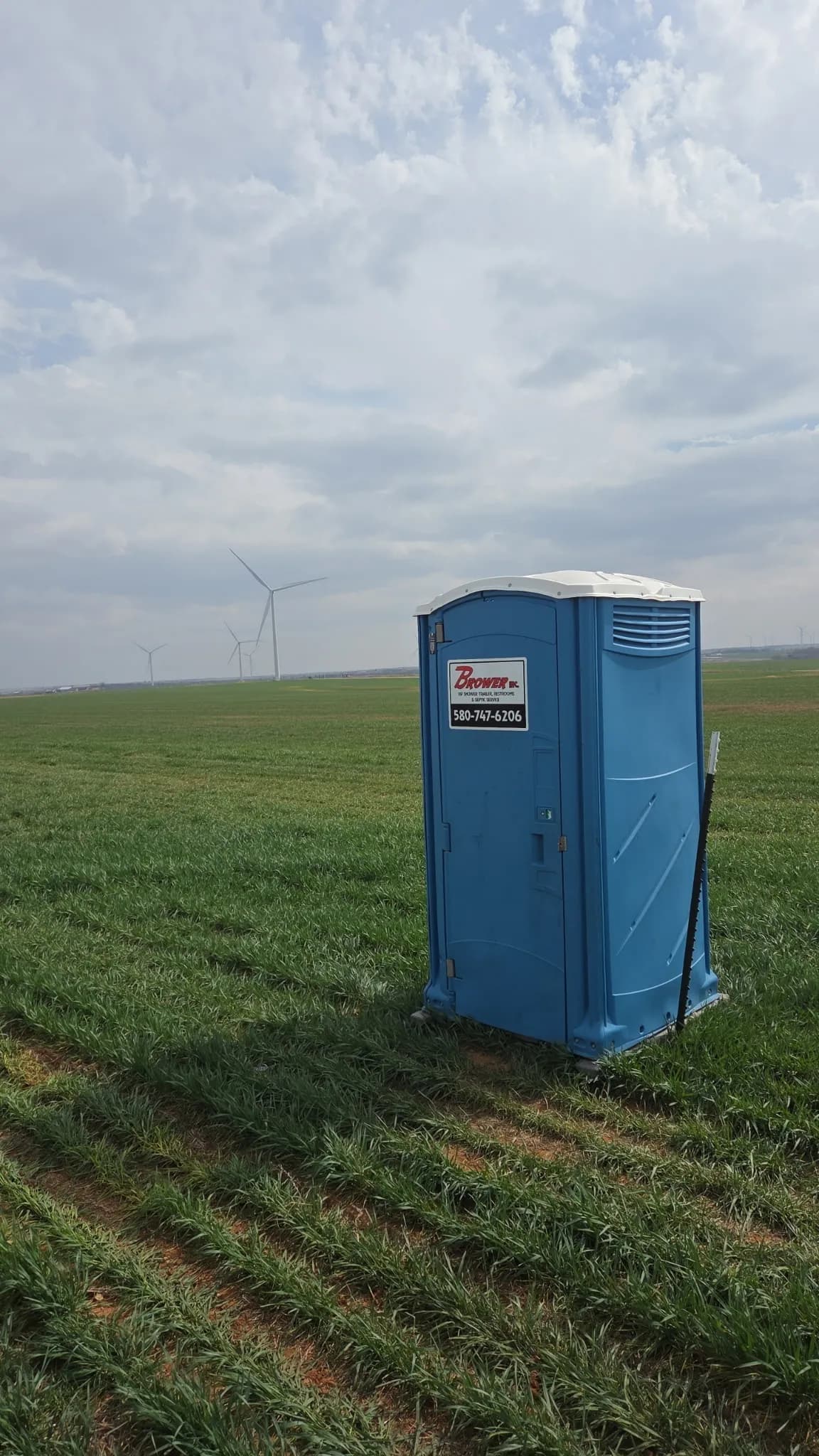 Brower Inc. portable restroom properly serviced and positioned at a wind farm field site in Newkirk, Oklahoma