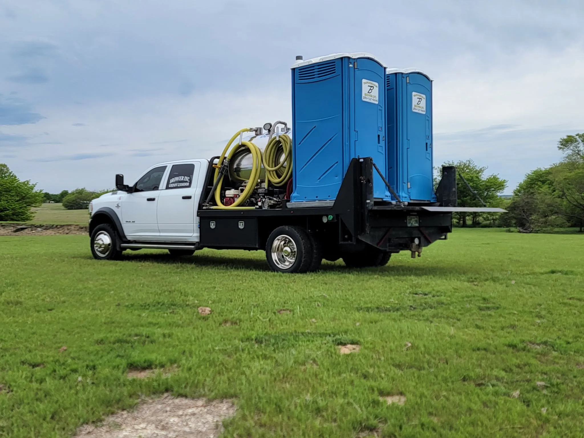 Brower Inc. portable restroom delivery truck serving utility crew work site in Oklahoma