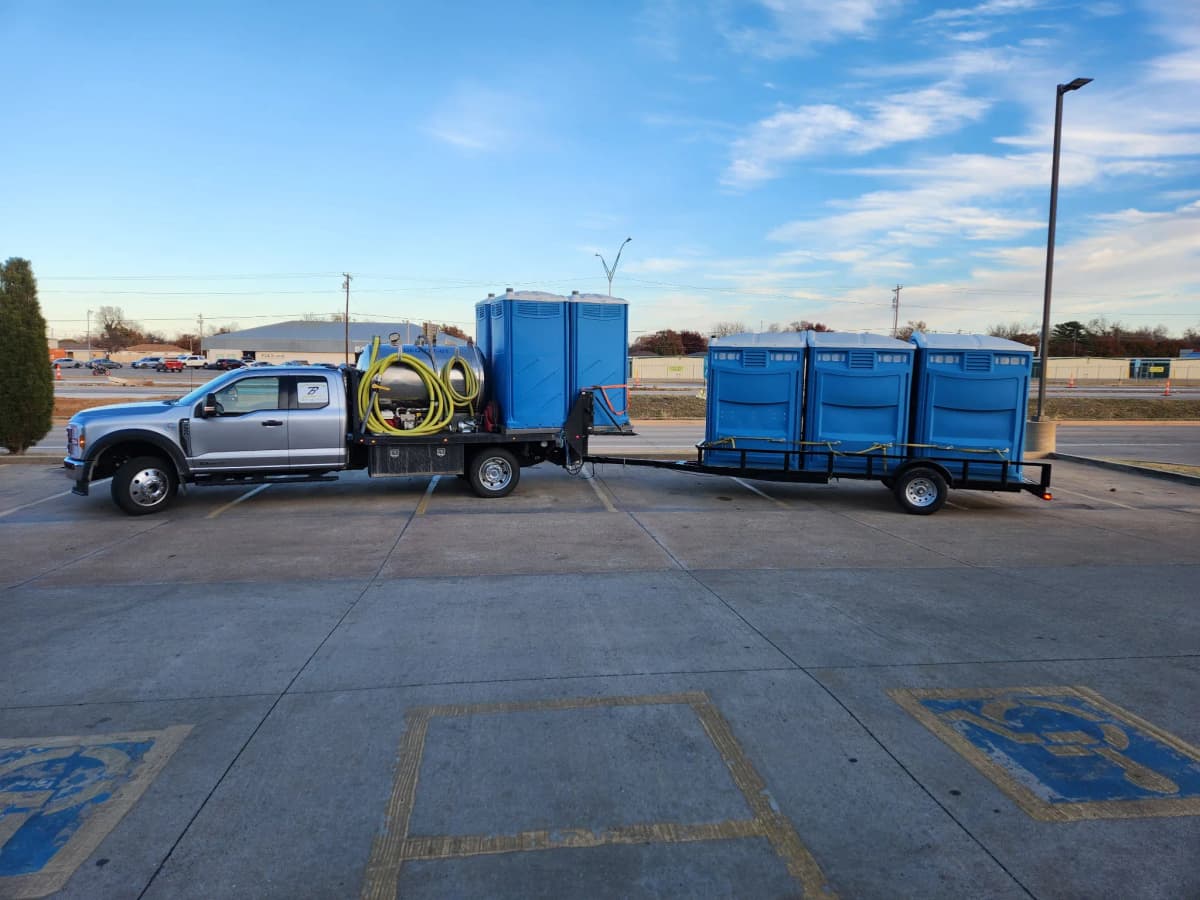 Brower Inc. truck and trailer hauling portable restrooms