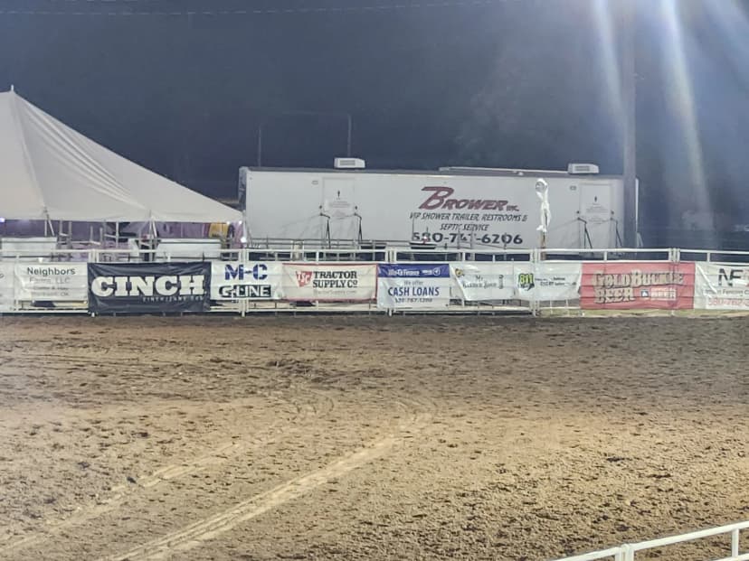 Brower Inc. VIP restroom trailer set up behind a rodeo arena
